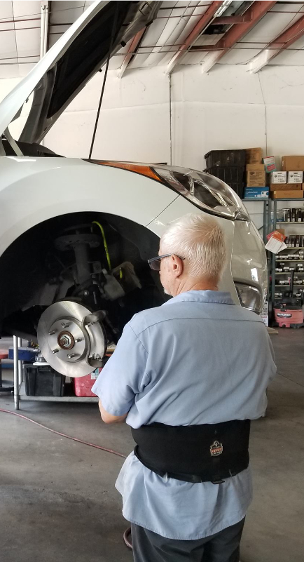 interior of shop - mechanic working on car disc